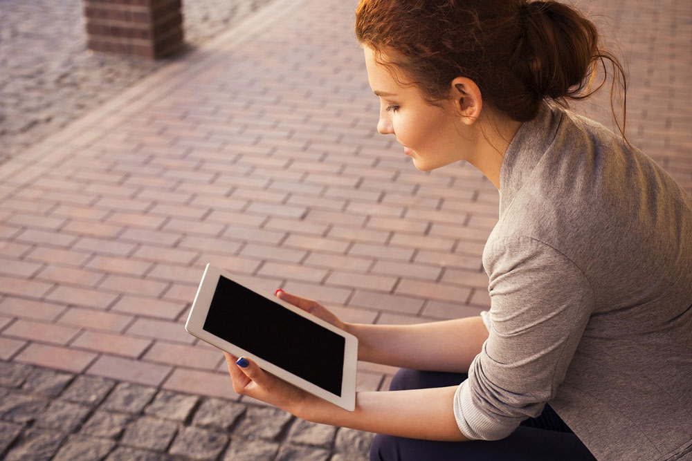 Woman reading on a tablet.